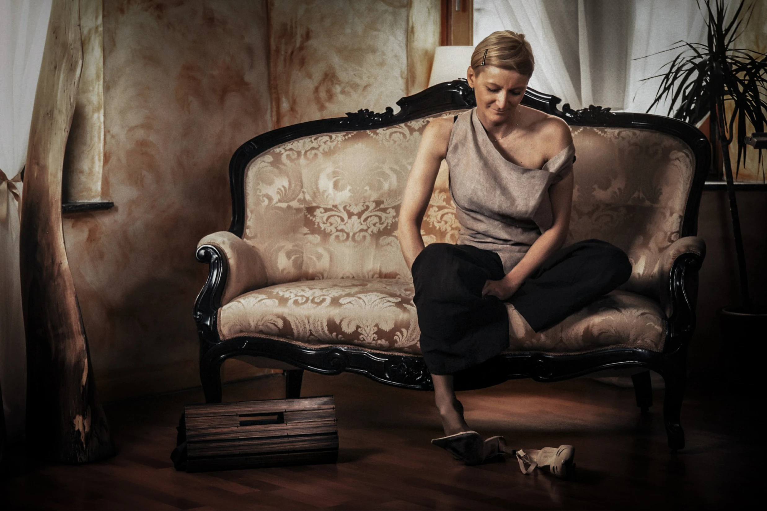 Fashion portrait of a woman seated on a sofa