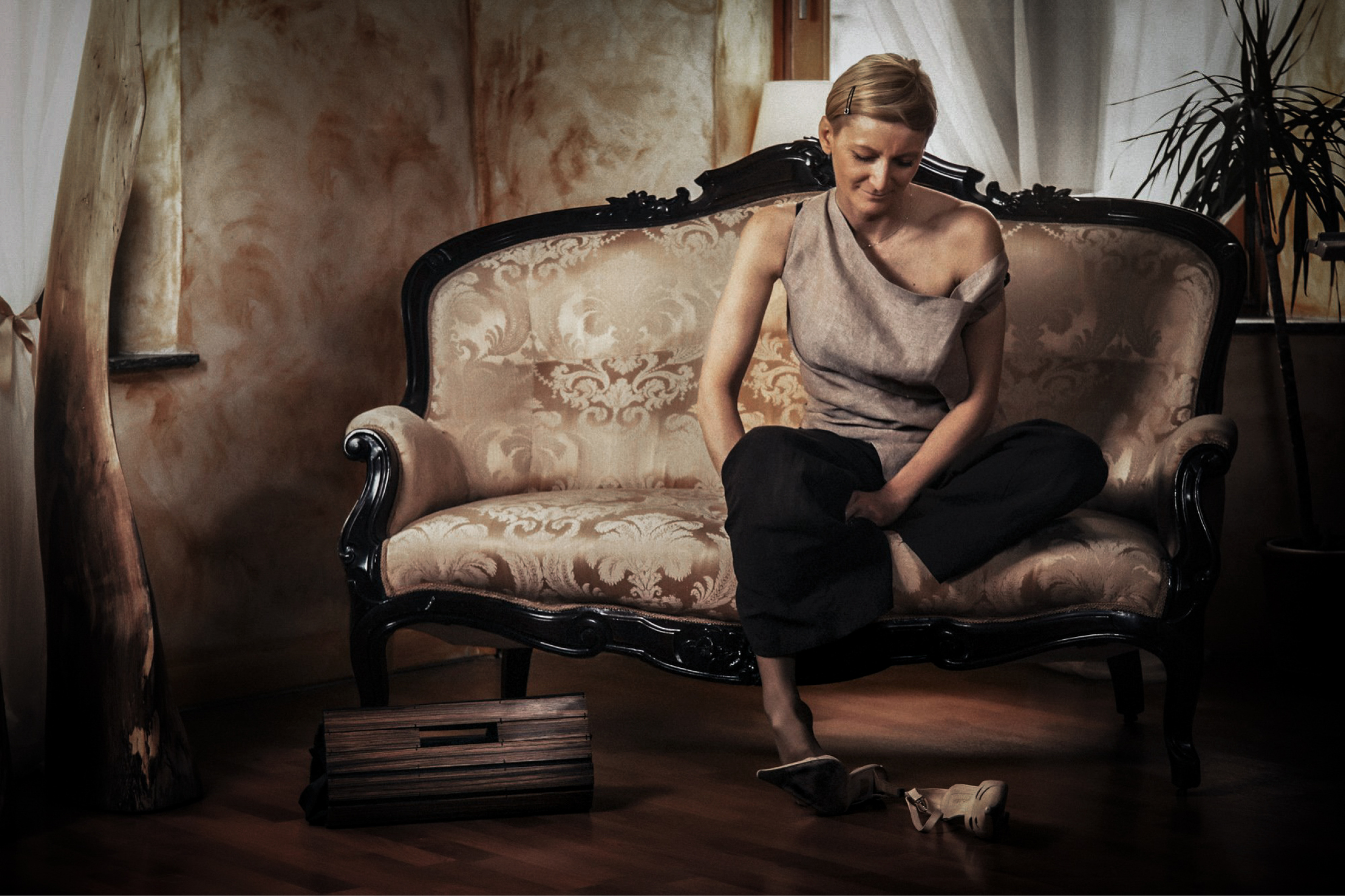Fashion portrait of a woman seated on a sofa